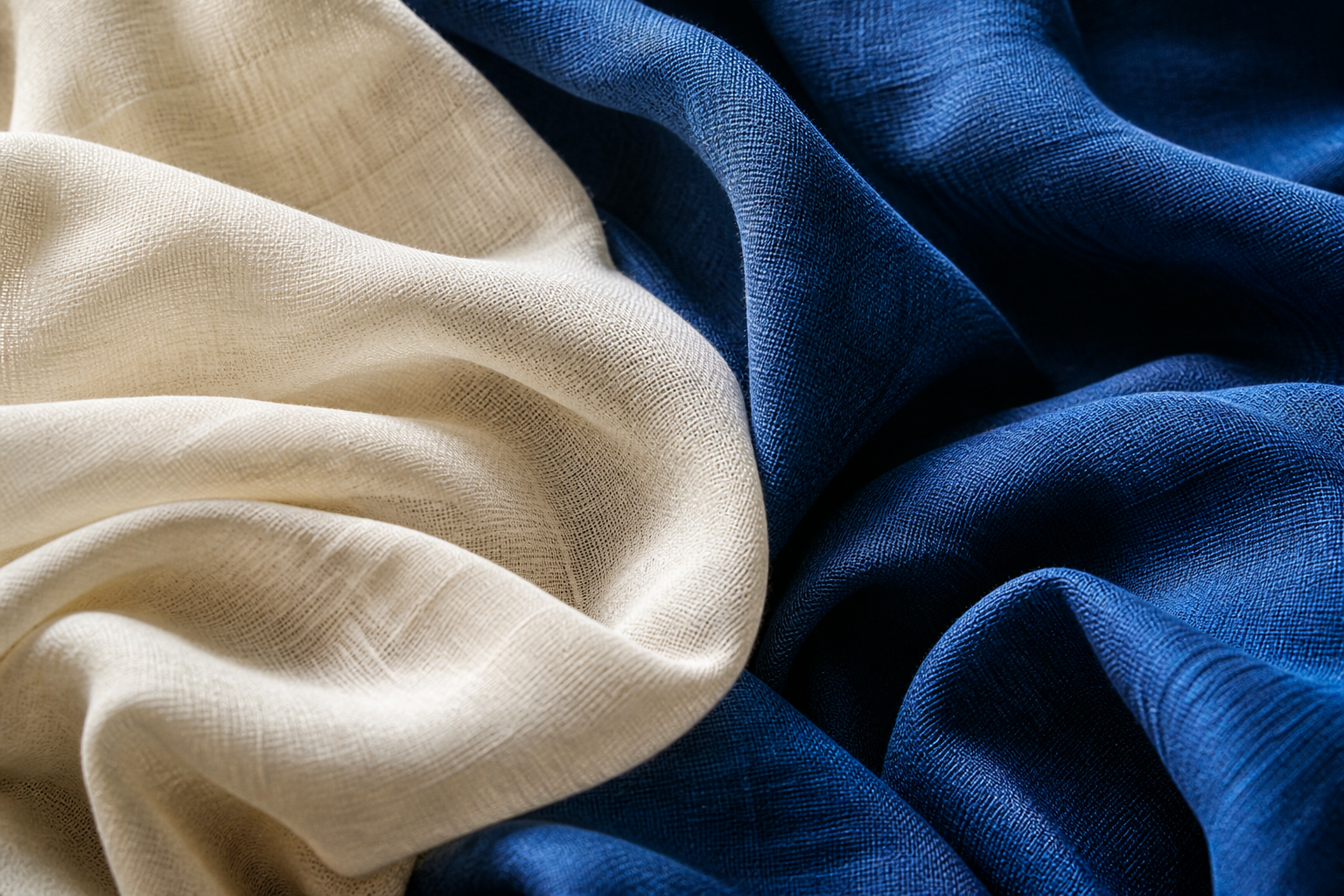 Sculptural folds of ivory and deep blue woven fabric